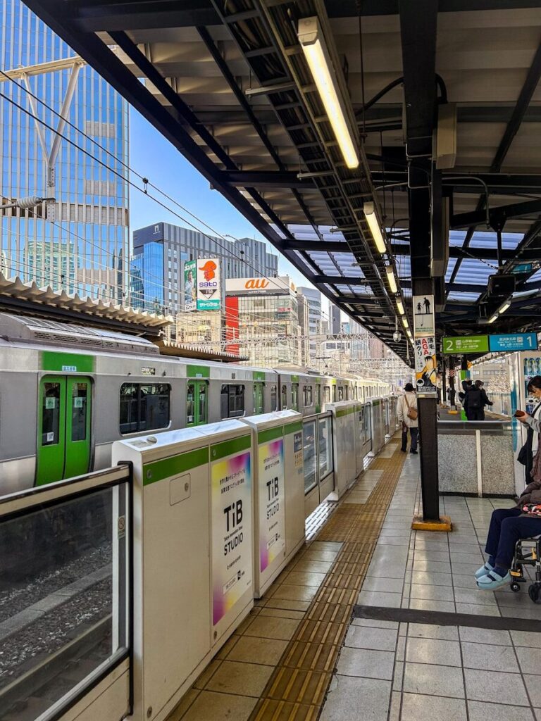 a subway station with people waiting for the train