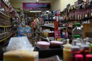 Shop aisle packed with colourful low-price household goods