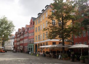 Tables, chairs and parasols on the square at Graabroedretorv in Copenhagen