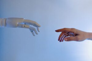 A human hand reaching towards a robotic hand